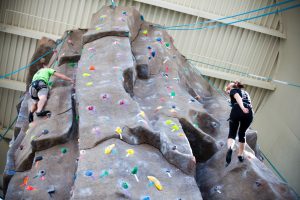 Students rock climb at the Recreation and Wellness Center